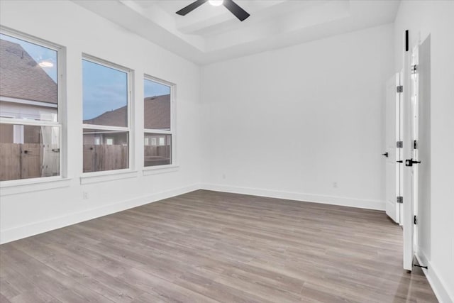 8609 San Giano Cv, Round Rock, TX 78665 - unfurnished room featuring a raised ceiling, ceiling fan, and wood finished floors