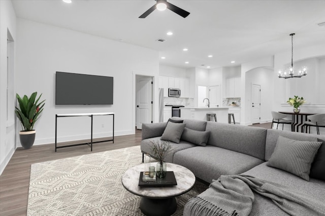 8609 San Giano Cv, Round Rock, TX 78665 - living area featuring ceiling fan, a chandelier, recessed lighting, and wood finished floors