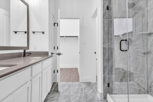 8609 San Giano Cv, Round Rock, TX 78665 - full bathroom with double vanity, a stall shower, and a walk in closet