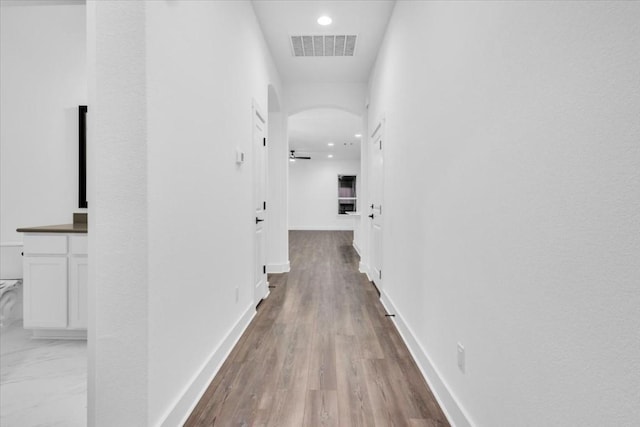 8609 San Giano Cv, Round Rock, TX 78665 - corridor featuring arched walkways, recessed lighting, and light wood-type flooring