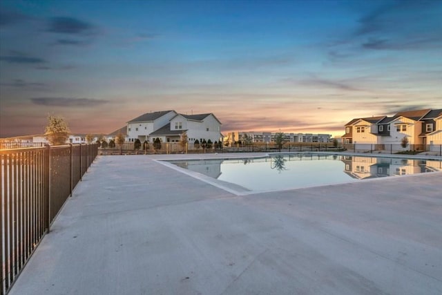 8609 San Giano Cv, Round Rock, TX 78665 - pool at dusk with a community pool, a residential view, and a patio
