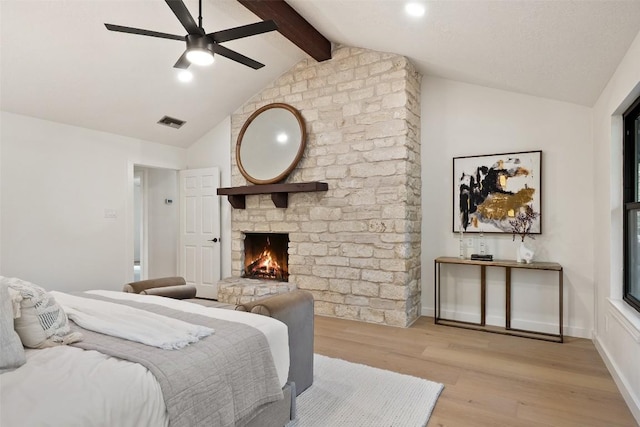 506 Explorer, Lakeway, TX 78734 - bedroom featuring light wood-style flooring, a fireplace, and ceiling fan
