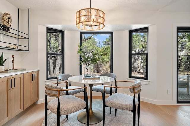 506 Explorer, Lakeway, TX 78734 - dining area with light wood-style flooring and a chandelier