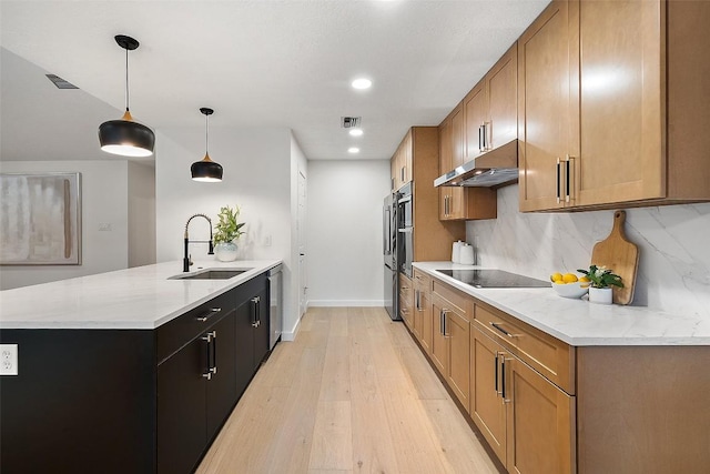506 Explorer, Lakeway, TX 78734 - kitchen featuring under cabinet range hood, dishwasher, black electric stovetop, a peninsula, and light wood-type flooring