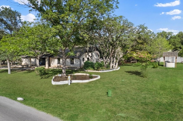 506 Explorer, Lakeway, TX 78734 - view of front of home with a front yard and an outdoor structure
