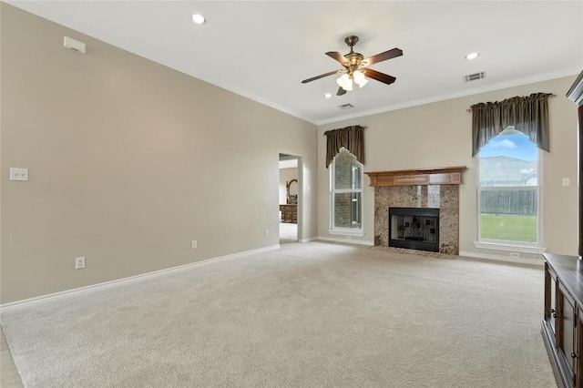 100 Davis Ct, Thorndale, TX 76577 - unfurnished living room with ceiling fan, crown molding, light colored carpet, a tiled fireplace, and recessed lighting
