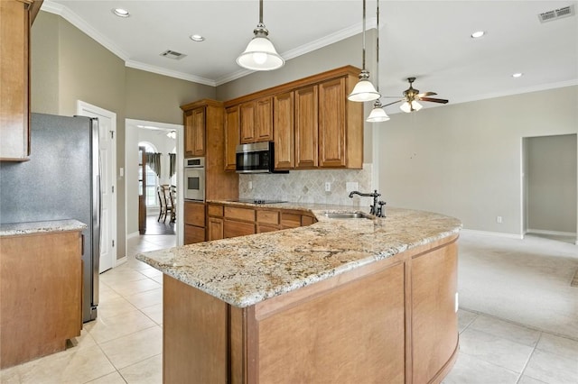 100 Davis Ct, Thorndale, TX 76577 - kitchen featuring appliances with stainless steel finishes, brown cabinetry, light tile patterned floors, a peninsula, and ceiling fan