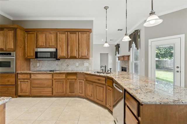 100 Davis Ct, Thorndale, TX 76577 - kitchen with stainless steel appliances, brown cabinetry, backsplash, light stone counters, and crown molding