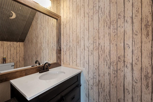 506 Turtle Back Cv, Killeen, TX 76542 - bathroom with vanity, wooden walls, and lofted ceiling