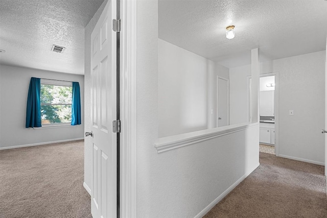 506 Turtle Back Cv, Killeen, TX 76542 - hallway featuring a textured ceiling and carpet floors