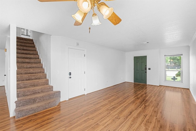 506 Turtle Back Cv, Killeen, TX 76542 - unfurnished living room featuring light wood-style floors, a ceiling fan, and stairway