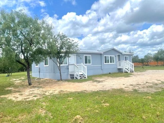 149 Gato Rd, Cedar Creek, TX 78612 - view of front of property with a front lawn