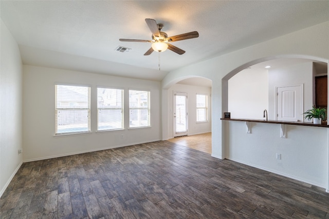 18824 Keeli Ln, Pflugerville, TX 78660 - unfurnished living room with a ceiling fan, wood finished floors, and arched walkways