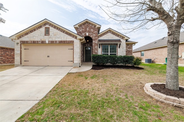 18824 Keeli Ln, Pflugerville, TX 78660 - view of front facade with an attached garage, concrete driveway, a front yard, and stone siding