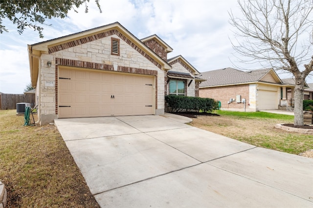 18824 Keeli Ln, Pflugerville, TX 78660 - view of front facade featuring stone siding, a garage, and driveway