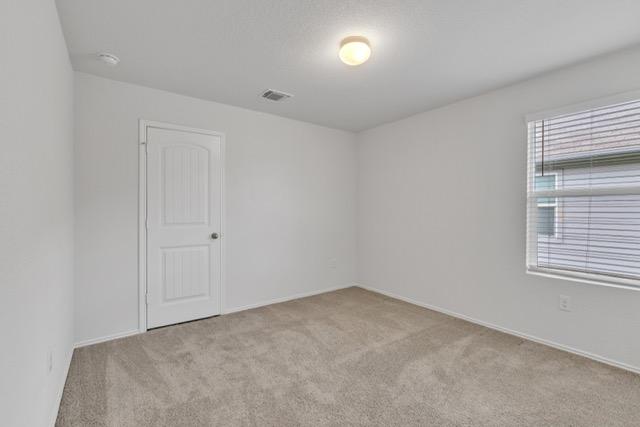 14802 Tuff Rd, Manor, TX 78653 - carpeted spare room featuring a smoke detector and baseboards
