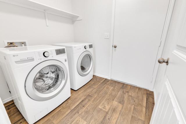 14802 Tuff Rd, Manor, TX 78653 - laundry area with washing machine and dryer and light wood finished floors