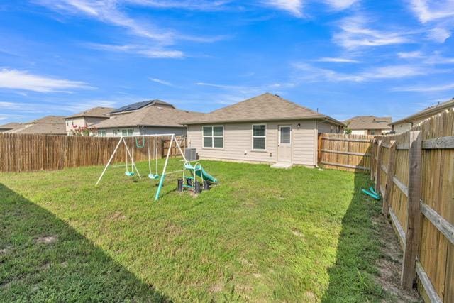 14802 Tuff Rd, Manor, TX 78653 - back of house featuring a playground and a fenced backyard