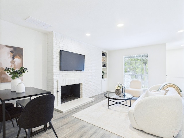 6108 Shadow Valley Dr Unit B, Austin, TX 78731 - living room featuring light wood-style floors, recessed lighting, a fireplace, and built in features