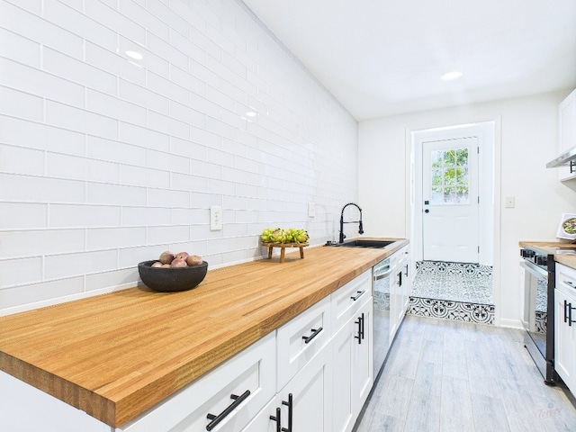 6108 Shadow Valley Dr Unit B, Austin, TX 78731 - kitchen with butcher block countertops, electric range, dishwasher, light wood-type flooring, and white cabinets