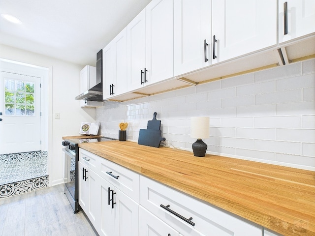 6108 Shadow Valley Dr Unit B, Austin, TX 78731 - kitchen with wall chimney range hood, stainless steel range with electric stovetop, white cabinets, decorative backsplash, and light wood-type flooring