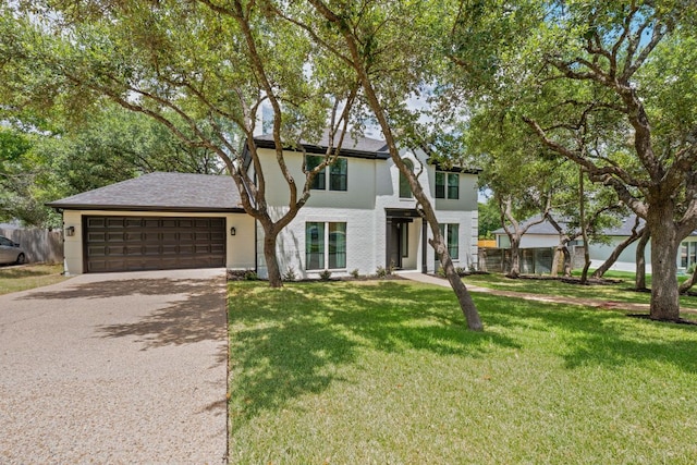 9402 Caracas Dr, Austin, TX 78733 - view of front of house with an attached garage, driveway, and a front yard