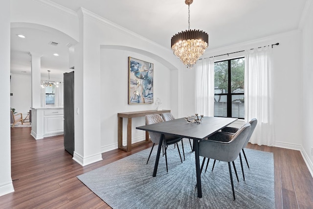 9402 Caracas Dr, Austin, TX 78733 - dining area with a chandelier, dark wood-style floors, ornamental molding, arched walkways, and recessed lighting