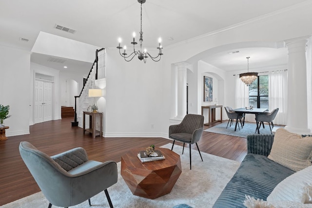 9402 Caracas Dr, Austin, TX 78733 - living room with a chandelier, arched walkways, ornate columns, wood finished floors, and stairway