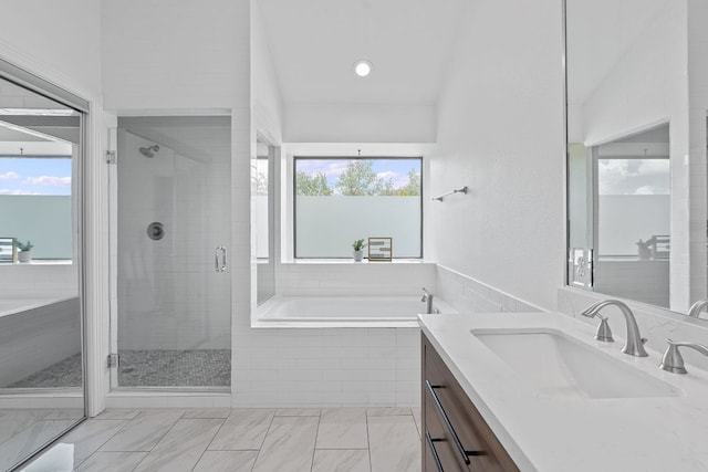 9402 Caracas Dr, Austin, TX 78733 - full bath featuring vanity, a garden tub, healthy amount of natural light, and a shower stall