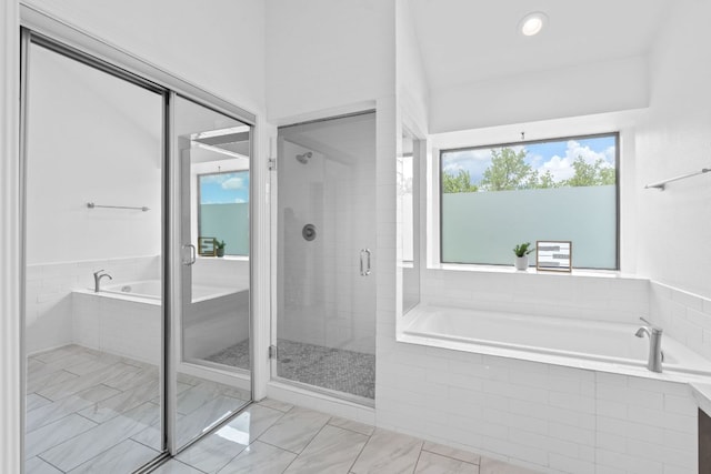 9402 Caracas Dr, Austin, TX 78733 - bathroom with a garden tub, a stall shower, and marble finish flooring