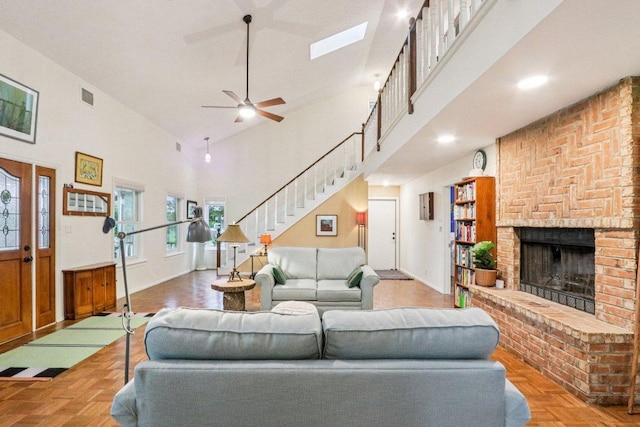 428 Gotier Trace Rd, Smithville, TX 78957 - living area with a fireplace, stairway, a towering ceiling, and a ceiling fan
