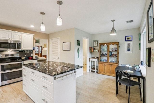 428 Gotier Trace Rd, Smithville, TX 78957 - kitchen featuring appliances with stainless steel finishes, decorative light fixtures, white cabinetry, a center island, and recessed lighting