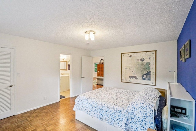 428 Gotier Trace Rd, Smithville, TX 78957 - bedroom featuring a textured ceiling and ensuite bath