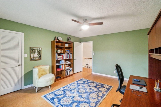 428 Gotier Trace Rd, Smithville, TX 78957 - home office featuring a ceiling fan, wood finished floors, and a textured ceiling