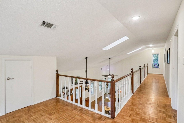 428 Gotier Trace Rd, Smithville, TX 78957 - hallway featuring lofted ceiling, a skylight, and a textured ceiling