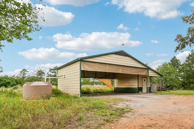 428 Gotier Trace Rd, Smithville, TX 78957 - view of outdoor structure with driveway and a carport