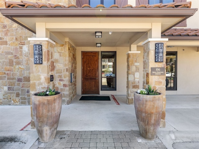 106 Bella Toscana Ave Unit 3204, Lakeway, TX 78734 - entrance to property featuring a tile roof, stone siding, and stucco siding