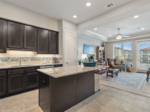 106 Bella Toscana Ave Unit 3204, Lakeway, TX 78734 - kitchen featuring a ceiling fan, recessed lighting, light stone countertops, tasteful backsplash, and dark brown cabinets