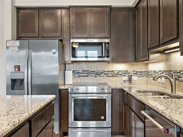 106 Bella Toscana Ave Unit 3204, Lakeway, TX 78734 - kitchen with appliances with stainless steel finishes, dark brown cabinets, and decorative backsplash