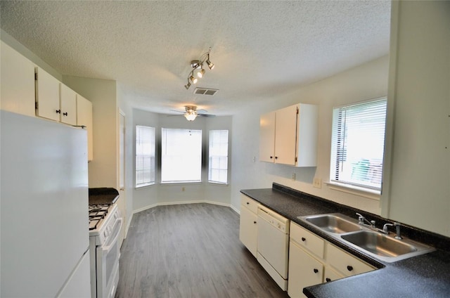 2200 Frontier Trl, Round Rock, TX 78681 - kitchen featuring white appliances, a ceiling fan, dark countertops, a textured ceiling, and dark wood finished floors