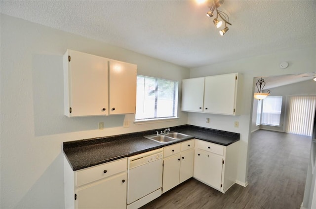 2200 Frontier Trl, Round Rock, TX 78681 - kitchen with white dishwasher, dark wood-style floors, a textured ceiling, dark countertops, and white cabinets