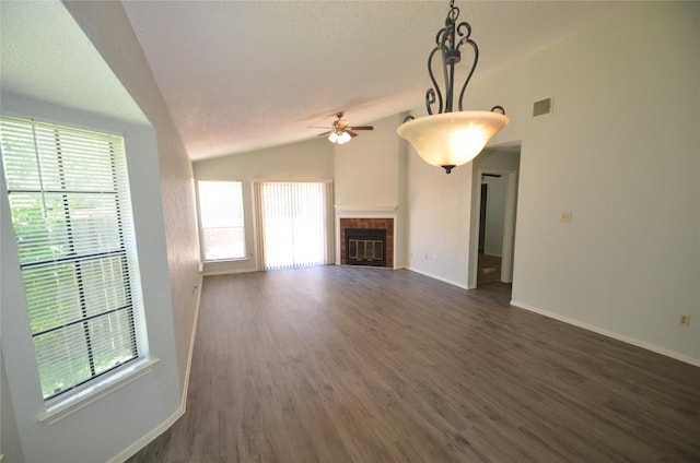 2200 Frontier Trl, Round Rock, TX 78681 - unfurnished living room with a ceiling fan, healthy amount of natural light, dark wood finished floors, vaulted ceiling, and a fireplace