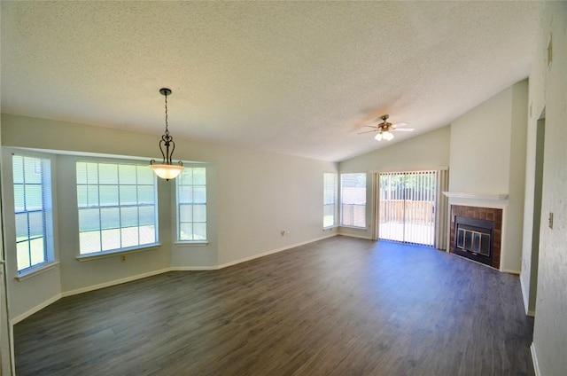 2200 Frontier Trl, Round Rock, TX 78681 - unfurnished living room with a ceiling fan, dark wood finished floors, healthy amount of natural light, a textured ceiling, and a fireplace