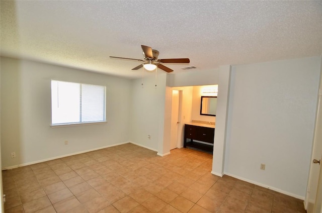 2200 Frontier Trl, Round Rock, TX 78681 - unfurnished bedroom with a textured ceiling and a ceiling fan