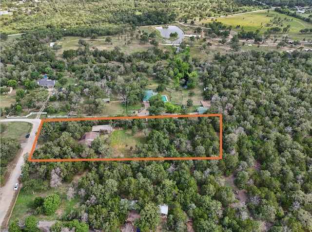 148 Oak Ridge Dr, Cedar Creek, TX 78612 - aerial overview of property's location with property parcel outlined and a nearby body of water