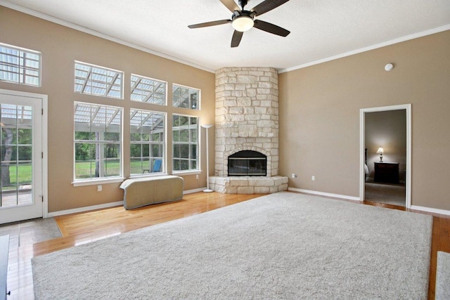 148 Oak Ridge Dr, Cedar Creek, TX 78612 - unfurnished living room with crown molding, a ceiling fan, wood finished floors, and a fireplace