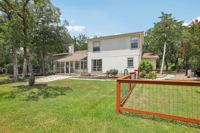 148 Oak Ridge Dr, Cedar Creek, TX 78612 - back of property featuring a sunroom and a yard