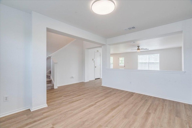618 Lavaca Loop, Elgin, TX 78621 - unfurnished room featuring light wood-style flooring, stairway, and a ceiling fan