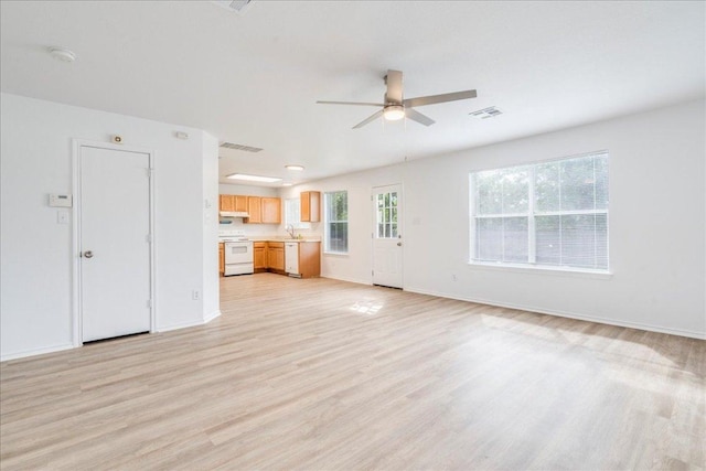 618 Lavaca Loop, Elgin, TX 78621 - unfurnished living room with a ceiling fan and light wood-type flooring