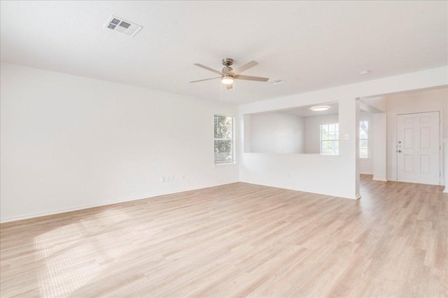 618 Lavaca Loop, Elgin, TX 78621 - unfurnished living room with light wood finished floors and a ceiling fan